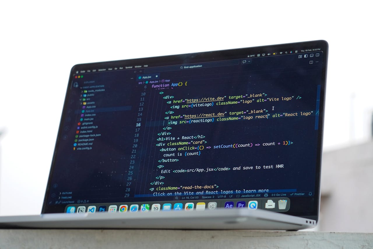 A developer codes on a laptop in an outdoor setting, showcasing modern web development in Surat, India.